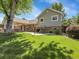 Expansive backyard featuring a well-maintained lawn, patio, and charming swing, perfect for outdoor living and entertaining at 6810 S Marion W Cir, Centennial, CO 80122