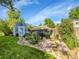 Landscaped backyard with garden shed, stone path, flower beds and well-maintained lawn creates a serene outdoor oasis at 6810 S Marion W Cir, Centennial, CO 80122