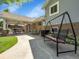 Expansive backyard featuring a covered patio, swing, lush lawn, mature trees, and privacy fencing at 6810 S Marion W Cir, Centennial, CO 80122
