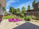 Well-maintained backyard with mature trees, vibrant flowers, a beautiful fountain, and a wooden fence at 6810 S Marion W Cir, Centennial, CO 80122