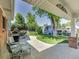 Private backyard featuring a covered patio, a garden shed, mature trees, and well-manicured landscaping at 6810 S Marion W Cir, Centennial, CO 80122