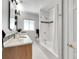 Bright bathroom with a tub-shower combination and vanity with neutral finishes at 6810 S Marion W Cir, Centennial, CO 80122
