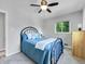 Bright bedroom with a window and a ceiling fan, featuring a wrought-iron bed frame at 6810 S Marion W Cir, Centennial, CO 80122