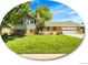 Charming two-story home featuring a well-manicured lawn, brick accents, and mature trees, set under a beautiful blue sky at 6810 S Marion W Cir, Centennial, CO 80122