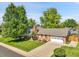 Charming exterior view of a well-maintained home with a lush green lawn and mature trees creates great curb appeal at 6810 S Marion W Cir, Centennial, CO 80122