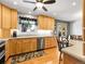 Spacious kitchen with light wood cabinets, stainless steel appliances, and a breakfast bar with views of the backyard at 6810 S Marion W Cir, Centennial, CO 80122