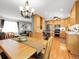 Bright kitchen and dining area featuring light wood cabinetry, stainless steel appliances, and a cozy seating area at 6810 S Marion W Cir, Centennial, CO 80122