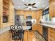 Modern kitchen featuring ample cabinet space, stainless steel appliances, and a breakfast bar with stylish seating at 6810 S Marion W Cir, Centennial, CO 80122