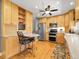 Well-equipped kitchen with light wood cabinets, stainless steel appliances, and a breakfast bar with seating at 6810 S Marion W Cir, Centennial, CO 80122