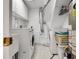 Bright laundry room with washer, dryer, sink, and storage cabinets at 6810 S Marion W Cir, Centennial, CO 80122
