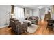 Cozy living room with hardwood floors, comfortable seating, and plenty of natural light filtering through large windows at 6810 S Marion W Cir, Centennial, CO 80122