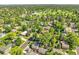 Aerial view of a neighborhood surrounded by lush greenery, mature trees, and a golf course in the distance at 6810 S Marion W Cir, Centennial, CO 80122