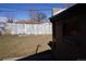 Backyard featuring a grass lawn, a wood fence, and the side of the house at 9191 Russell Way, Thornton, CO 80229