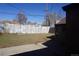Backyard featuring a grass lawn, a wood fence, and the side of the house at 9191 Russell Way, Thornton, CO 80229