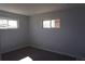Neutral painted bedroom with carpet, base trim, and two windows for ample natural light at 9191 Russell Way, Thornton, CO 80229