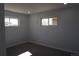 Neutral painted bedroom with carpet, base trim, and two windows for ample natural light at 9191 Russell Way, Thornton, CO 80229