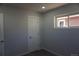 Bedroom featuring neutral paint, carpet, base trim, door and window at 9191 Russell Way, Thornton, CO 80229