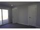 Bedroom featuring carpet floors, a sliding glass door, and a standard door at 9191 Russell Way, Thornton, CO 80229