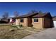 Charming brick home with well-kept lawn, updated windows and an American flag at 9191 Russell Way, Thornton, CO 80229