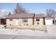 Charming brick home featuring a well-maintained lawn and a detached one car garage at 9191 Russell Way, Thornton, CO 80229