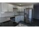 Bright kitchen featuring stainless steel appliances, granite counters and modern white cabinets at 9191 Russell Way, Thornton, CO 80229