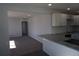 Open concept kitchen with granite countertops, stainless appliances, white cabinets, flowing into a carpeted living area at 9191 Russell Way, Thornton, CO 80229