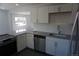 Bright kitchen featuring white cabinets, granite countertops, stainless steel appliances, and stylish backsplash at 9191 Russell Way, Thornton, CO 80229