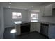Bright kitchen with granite countertops, stainless steel appliances and white cabinets at 9191 Russell Way, Thornton, CO 80229