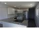 Modern kitchen with granite countertops, stainless steel appliances, white cabinets, and recessed lighting at 9191 Russell Way, Thornton, CO 80229