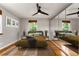 Cozy bedroom featuring a large window, hardwood floors, and a mirrored closet at 1535 Hudson St # 1, Denver, CO 80220