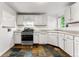 Well-lit kitchen with white cabinetry, stainless steel appliances, and eye-catching tile floors at 1535 Hudson St # 1, Denver, CO 80220