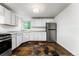 Bright kitchen featuring white cabinetry, stainless steel appliances, and distinctive tile flooring at 1535 Hudson St # 1, Denver, CO 80220