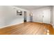 Open-concept living room with hardwood floors, natural light, and a pass-through to the kitchen at 1535 Hudson St # 1, Denver, CO 80220