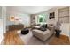 Inviting living room featuring a large sectional, wood floors, and abundant natural light at 1535 Hudson St # 1, Denver, CO 80220