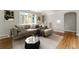 Comfortable living room featuring a large sectional, neutral tones, and wood floors at 1535 Hudson St # 1, Denver, CO 80220