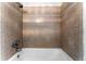 Tile-lined bathtub and shower, adding a touch of elegance to this cozy bathroom at 1535 Hudson St # 1, Denver, CO 80220