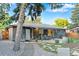 Private backyard featuring a stone patio with dining area, mature landscaping, and inviting outdoor space at 4100 Shaw Blvd, Westminster, CO 80031