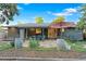 Private backyard featuring a stone patio with dining area, mature landscaping, and inviting outdoor space at 4100 Shaw Blvd, Westminster, CO 80031