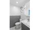 Stylish bathroom featuring a modern vanity, updated toilet, and striking patterned wall at 4100 Shaw Blvd, Westminster, CO 80031