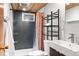 Modern bathroom featuring tile shower, stylish fixtures, and space-saving shelving for a sleek and functional design at 4100 Shaw Blvd, Westminster, CO 80031
