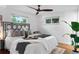 Serene bedroom featuring a stylish bed, ample natural light, and modern ceiling fan at 4100 Shaw Blvd, Westminster, CO 80031