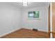 Bright bedroom with hardwood floors and a view of the outdoors through a large window at 4100 Shaw Blvd, Westminster, CO 80031