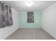 A simple, carpeted bedroom with gray walls and gray curtains offering a neutral and calming space at 4100 Shaw Blvd, Westminster, CO 80031