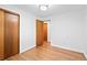 Well-lit bedroom showcasing hardwood floors, a spacious closet, and a neutral color palette at 4100 Shaw Blvd, Westminster, CO 80031