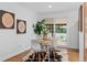 Bright dining room with hardwood floors, modern table setting, and sliding glass door to the backyard at 4100 Shaw Blvd, Westminster, CO 80031