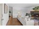 Inviting living room featuring hardwood floors, stylish fireplace, and comfortable sofa for gatherings at 4100 Shaw Blvd, Westminster, CO 80031