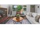 Cozy living room featuring large window, modern fireplace, and stylish furniture for a comfortable ambiance at 4100 Shaw Blvd, Westminster, CO 80031
