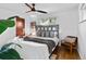 Bright main bedroom with hardwood floors, ceiling fan, and comfortable seating area for relaxation at 4100 Shaw Blvd, Westminster, CO 80031