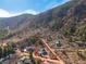 Aerial view highlighting the property boundaries on a hillside surrounded by lush trees and landscape at 402 Roosevelt St, Palmer Lake, CO 80133