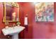 Stylish powder room showcasing a unique vanity sink, decorative painting, and lovely wall art at 402 Roosevelt St, Palmer Lake, CO 80133